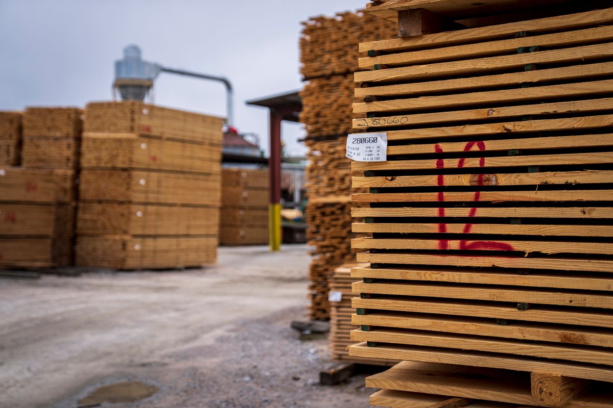 Stickered softwood lumber packs staged in a working mill yard